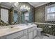 Cozy bathroom with floral wallpaper, double sink vanity, and ample natural light at 315 Dumont Dr, Hillsborough, NC 27278