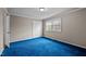 Bedroom featuring plush blue carpeting, window, and neutral color palette at 315 Dumont Dr, Hillsborough, NC 27278