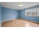 Bedroom featuring laminate floor, large window, and neutral color palette at 315 Dumont Dr, Hillsborough, NC 27278