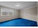 Bedroom featuring plush blue carpeting, window, and neutral color palette at 315 Dumont Dr, Hillsborough, NC 27278