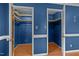 Dual walk-in closets featuring wood shelving and laminate flooring at 315 Dumont Dr, Hillsborough, NC 27278