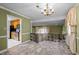 Open dining area featuring a chandelier and views into the living room and kitchen at 315 Dumont Dr, Hillsborough, NC 27278