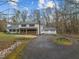 Spacious driveway leading to a two-car garage surrounded by lush greenery at 315 Dumont Dr, Hillsborough, NC 27278