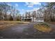 Charming two-story white home with black shutters and a large driveway lined with mature trees at 315 Dumont Dr, Hillsborough, NC 27278