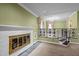 Bright living room featuring a fireplace, elegant trim, and staircase at 315 Dumont Dr, Hillsborough, NC 27278