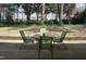Serene backyard featuring a glass table with green chairs and lush greenery at 3516 Apache Dr, Raleigh, NC 27609