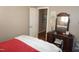 Comfortable bedroom featuring a makeup vanity, plush comforter and view into the hallway at 3516 Apache Dr, Raleigh, NC 27609