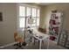 Bedroom features a desk, white shelving unit and a large window with plantation shutters at 3516 Apache Dr, Raleigh, NC 27609