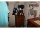 Walk-in closet features wooden chest of drawers and a display of accessories and jewelry at 3516 Apache Dr, Raleigh, NC 27609