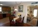 Cozy dining room featuring a wooden table with seating for four, and view into the living room at 3516 Apache Dr, Raleigh, NC 27609