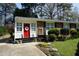 Charming brick home featuring a bright red door, white trim, and well-manicured front yard at 3516 Apache Dr, Raleigh, NC 27609