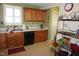 Traditional kitchen with wooden cabinets, stainless steel sink, and updated appliances at 3516 Apache Dr, Raleigh, NC 27609