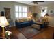 Inviting living room with hardwood floors, a plush blue sofa and lots of natural light at 3516 Apache Dr, Raleigh, NC 27609