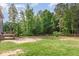 Extensive backyard with a wooden deck and privacy fence backing to a lush tree line at 40 Poplar Bark Dr, Youngsville, NC 27596