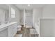 Bright bathroom featuring a shower, soaking tub, vanity, white cabinets, and wood-look floors at 40 Poplar Bark Dr, Youngsville, NC 27596