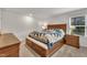 Spacious bedroom featuring a wooden bed with built in storage and two matching nightstands at 40 Poplar Bark Dr, Youngsville, NC 27596