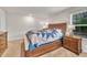 Bright bedroom boasts a wooden bed frame with two matching nightstands for comfort at 40 Poplar Bark Dr, Youngsville, NC 27596