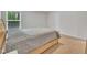 Bedroom showcasing natural light, neutral walls, carpet, and a wooden bed frame with a patterned comforter at 40 Poplar Bark Dr, Youngsville, NC 27596