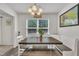 Bright dining room with large window, farmhouse style table, bench seating and elegant lighting at 40 Poplar Bark Dr, Youngsville, NC 27596