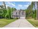 Beautiful two-story home with a long driveway and well-maintained lawn surrounded by lush trees at 40 Poplar Bark Dr, Youngsville, NC 27596