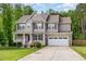 Charming two-story home featuring stone accents, manicured lawn and an attached two-car garage at 40 Poplar Bark Dr, Youngsville, NC 27596