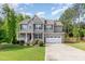 Charming two-story home featuring stone accents, manicured lawn and an attached two-car garage at 40 Poplar Bark Dr, Youngsville, NC 27596