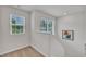 Well-lit stairway landing featuring neutral walls and natural light from the window at 40 Poplar Bark Dr, Youngsville, NC 27596