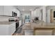 Spacious open-concept kitchen with white cabinets, granite counters, and stainless steel appliances at 40 Poplar Bark Dr, Youngsville, NC 27596