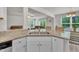 Open-concept kitchen with granite countertops, stainless steel sink, and view into the living area at 40 Poplar Bark Dr, Youngsville, NC 27596