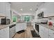 Bright and airy kitchen equipped with white cabinetry, granite countertops and stainless steel appliances at 40 Poplar Bark Dr, Youngsville, NC 27596