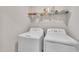 Functional laundry room with modern white washing machine and dryer on white walls at 40 Poplar Bark Dr, Youngsville, NC 27596
