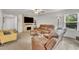 Cozy living room with a stacked stone fireplace, plush seating and abundant natural light at 40 Poplar Bark Dr, Youngsville, NC 27596