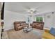 Spacious living room with comfortable seating, stone fireplace, and natural light from windows at 40 Poplar Bark Dr, Youngsville, NC 27596