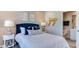Beautiful bedroom features a navy blue headboard, side tables with lamps, and decorative wall hangings at 404 Deercroft Dr, Apex, NC 27539