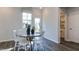 Dining room features a round table, white chairs, and access to the outdoor space at 404 Deercroft Dr, Apex, NC 27539