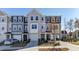 Attractive townhome with varying shades of gray, eye-catching windows, and neatly kept landscaping at 404 Deercroft Dr, Apex, NC 27539