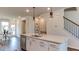 Bright kitchen island with stainless steel appliances and pendant lighting at 404 Deercroft Dr, Apex, NC 27539