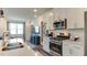Modern kitchen featuring a center island, stainless steel appliances, and an open-concept design at 404 Deercroft Dr, Apex, NC 27539