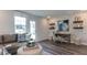 Bright living room with modern decor, including a stylish desk, wallpaper, and comfortable seating at 404 Deercroft Dr, Apex, NC 27539