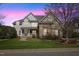 Charming two-story home featuring a landscaped front yard, stone accents, and a welcoming front porch at 404 Vintage Hill Cir, Apex, NC 27539