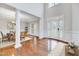 Bright foyer with hardwood floors, high ceilings, columns, and a charming double-door entrance at 404 Vintage Hill Cir, Apex, NC 27539