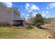 Backyard with lake view features a raised deck with stairs to the lawn and planting beds at 404 Vintage Hill Cir, Apex, NC 27539
