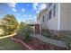 Landscaped backyard with lush lawn, planting beds, deck with stairs and a view of the lake at 404 Vintage Hill Cir, Apex, NC 27539