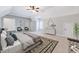 Spacious bedroom with sitting area, accent rug, and neutral color palette offers a peaceful retreat at 404 Vintage Hill Cir, Apex, NC 27539