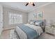 Comfortable bedroom features a queen bed, a ceiling fan, and white plantation shutters on the windows at 404 Vintage Hill Cir, Apex, NC 27539