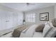 Relaxing bedroom with white bedding, natural light from the window, and ample closet space at 404 Vintage Hill Cir, Apex, NC 27539