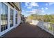 Spacious deck with white railings, wood flooring, and view of the backyard and wooded area at 404 Vintage Hill Cir, Apex, NC 27539