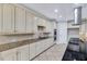 Modern kitchen featuring granite countertops, stainless steel appliances, and tile backsplash at 404 Vintage Hill Cir, Apex, NC 27539
