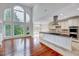 Elegant living room open to a kitchen featuring a large window and neutral colors at 404 Vintage Hill Cir, Apex, NC 27539