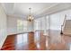 Spacious living area with hardwood floors, natural light, and elegant chandelier at 404 Vintage Hill Cir, Apex, NC 27539